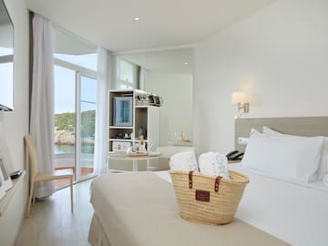 a basket of towels on a bed in a hotel room