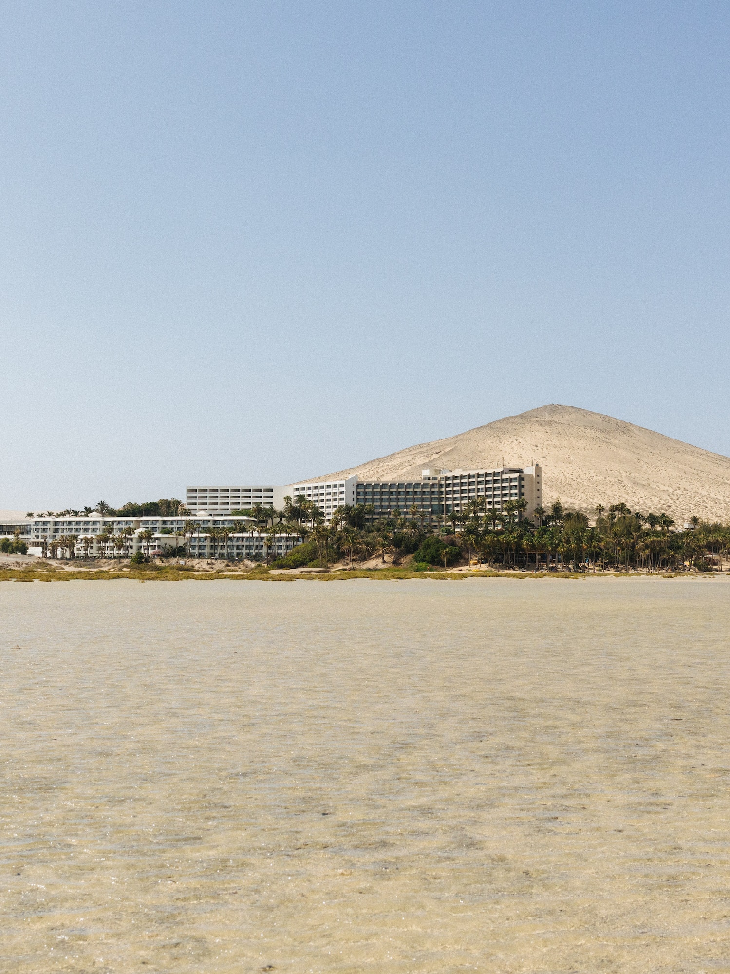a large body of water with a building on the side