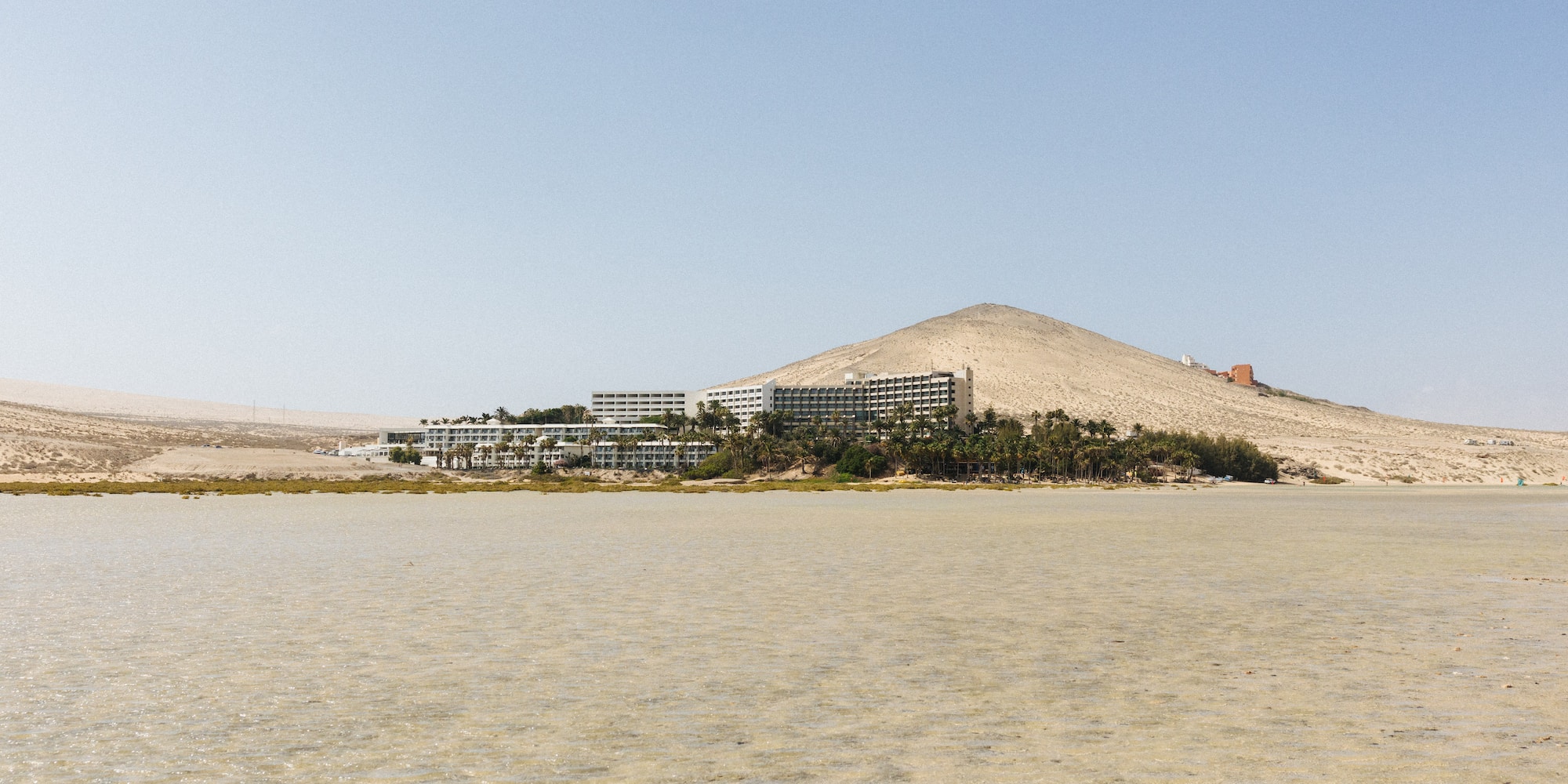a large body of water with a building on the side