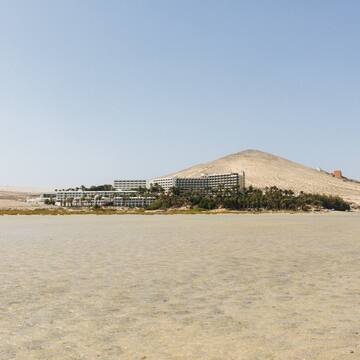 a large body of water with a building on the side
