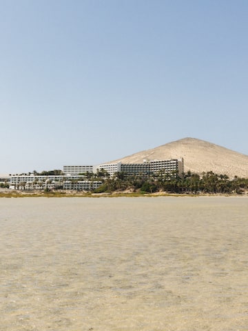 a large body of water with a building on the side