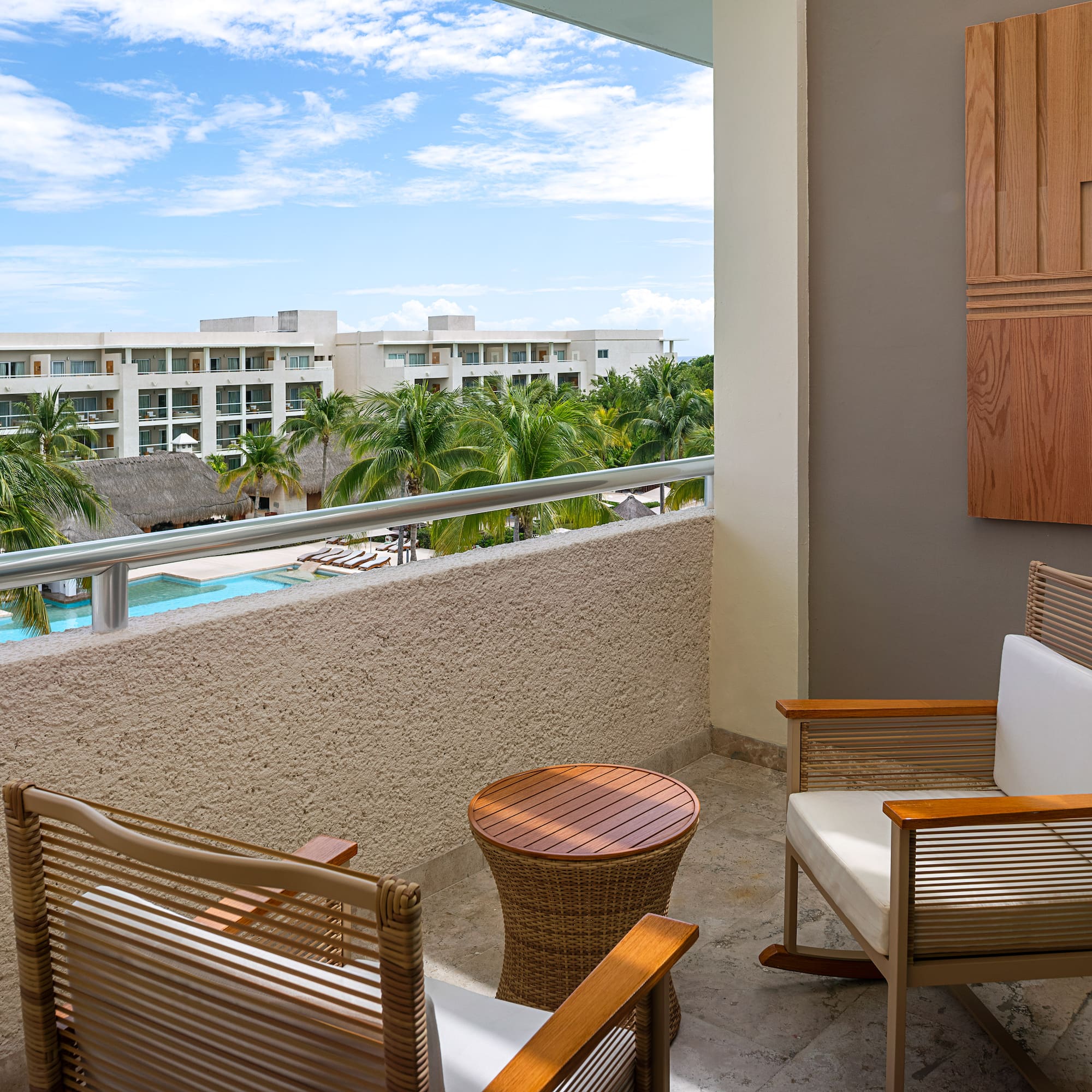 a chair and table on a balcony