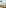 Coastal dining area with sea view, sandy beach, and distant rocky island.