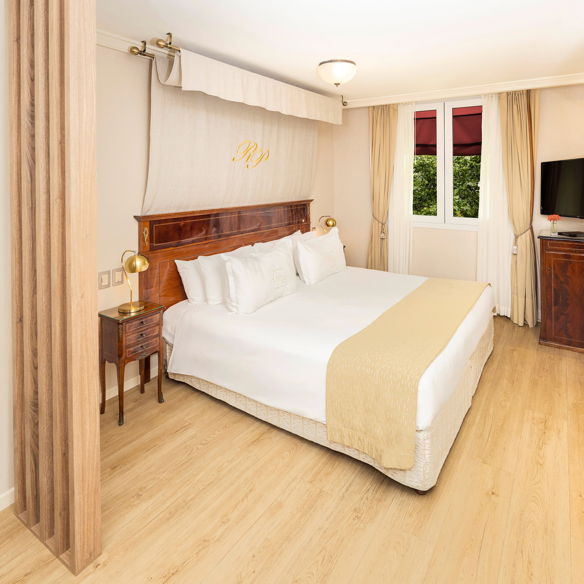 a bedroom with a bed and a tv