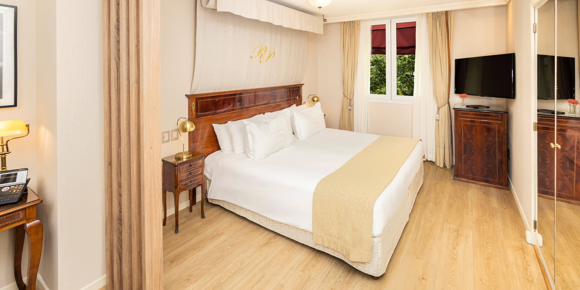 a bedroom with a bed and a tv