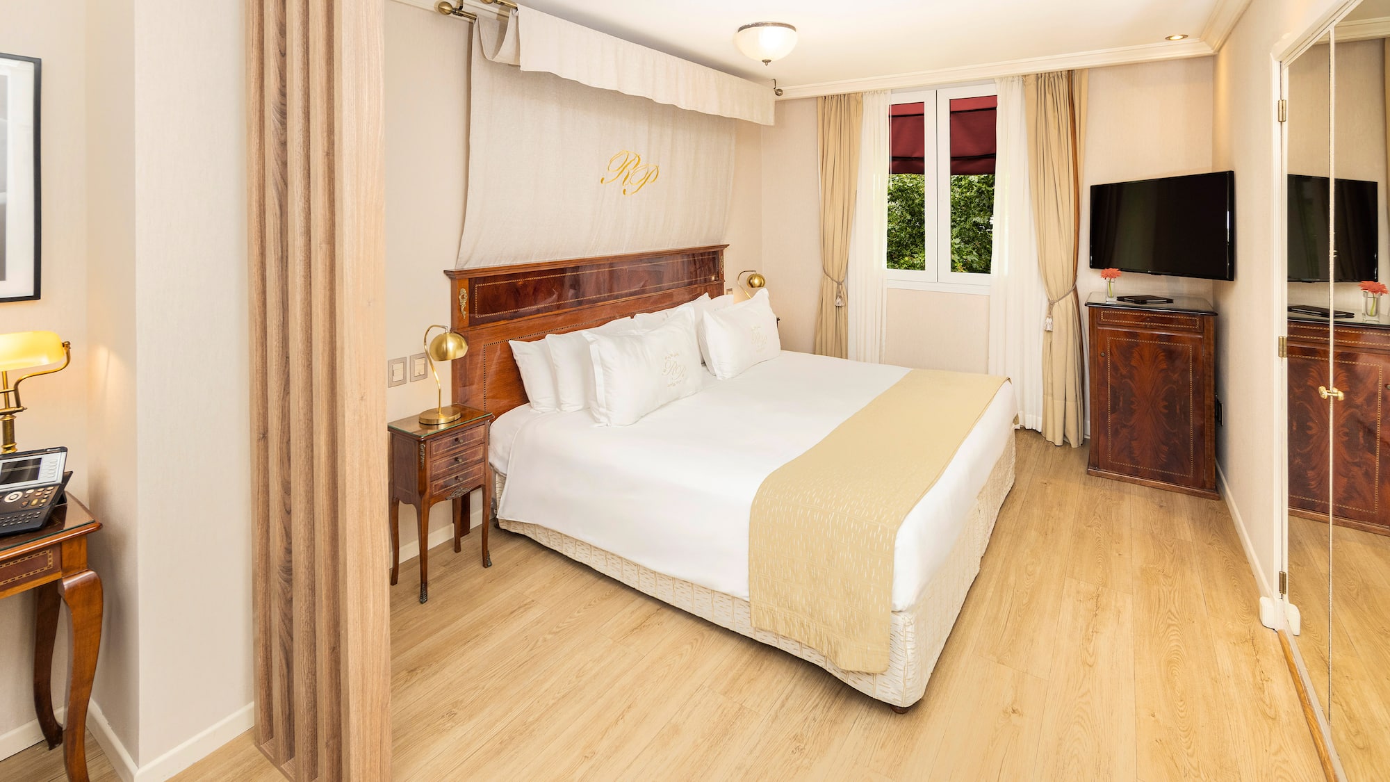 a bedroom with a bed and a tv