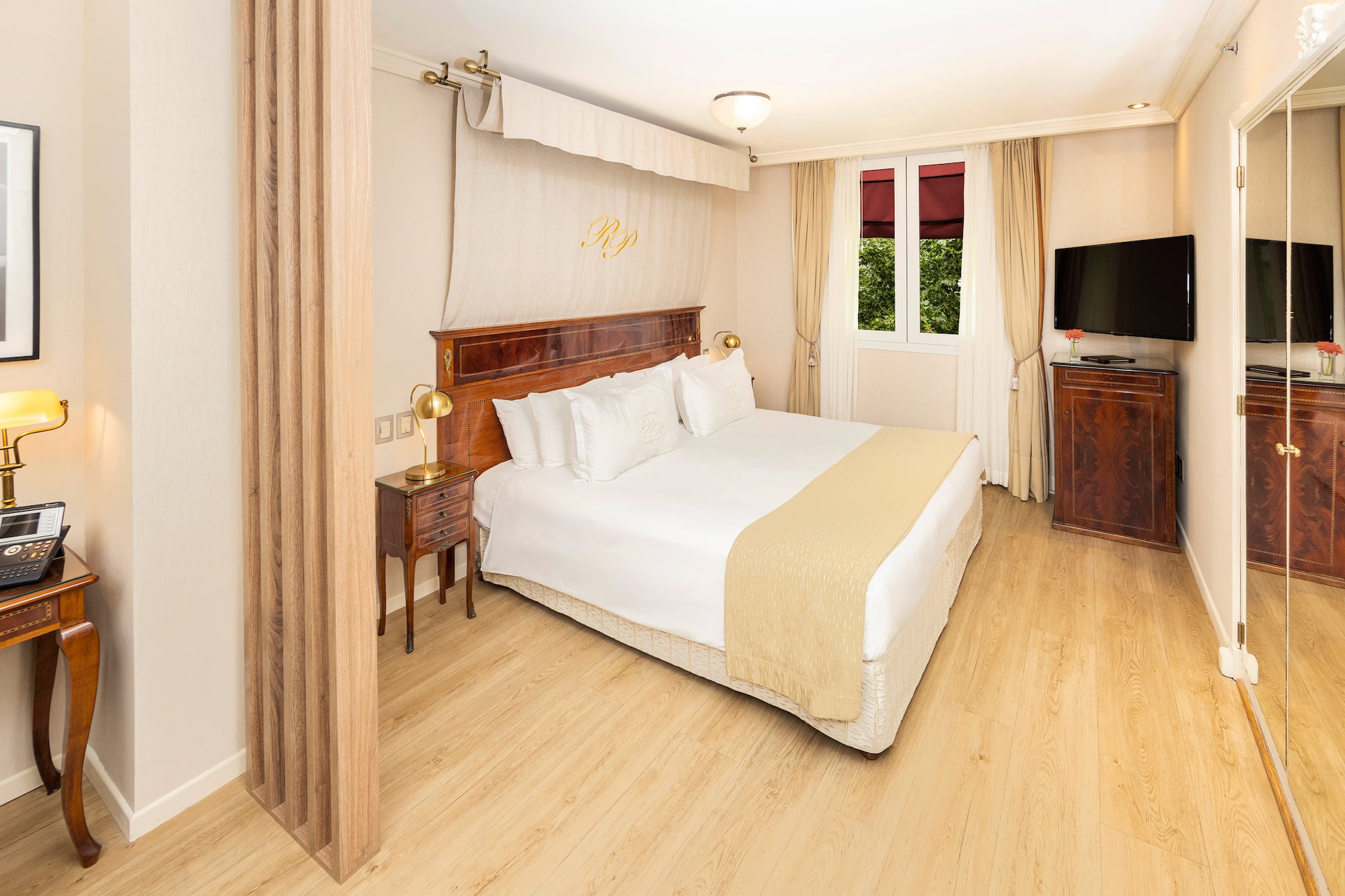 a bedroom with a bed and a tv