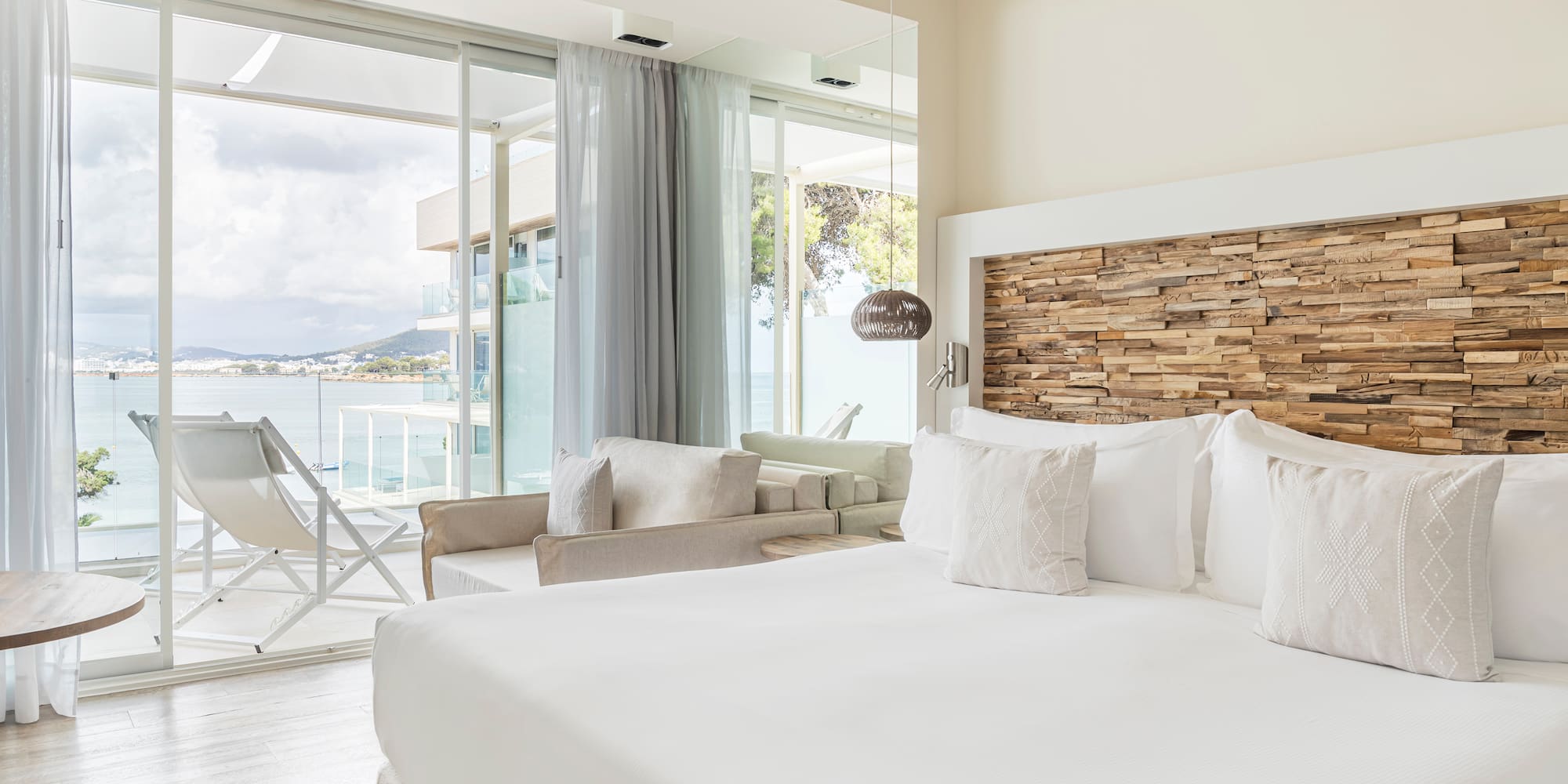 a bedroom with a large bed and a large window