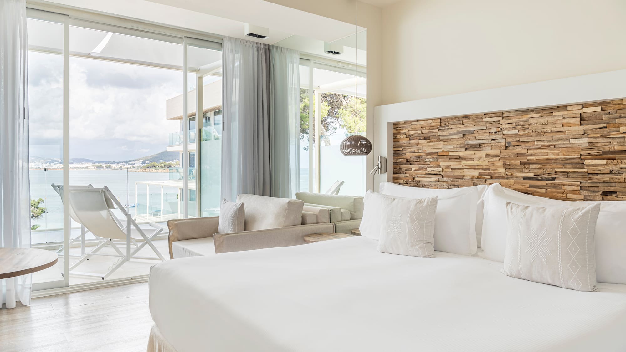 a bedroom with a large bed and a large window