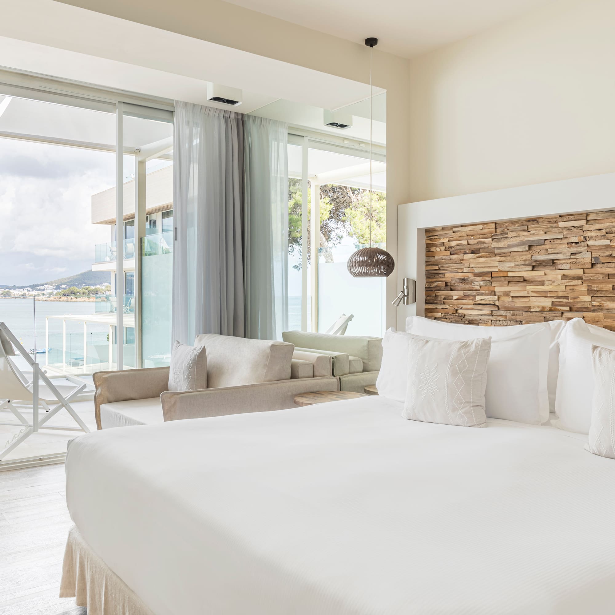 a bedroom with a large bed and a large window