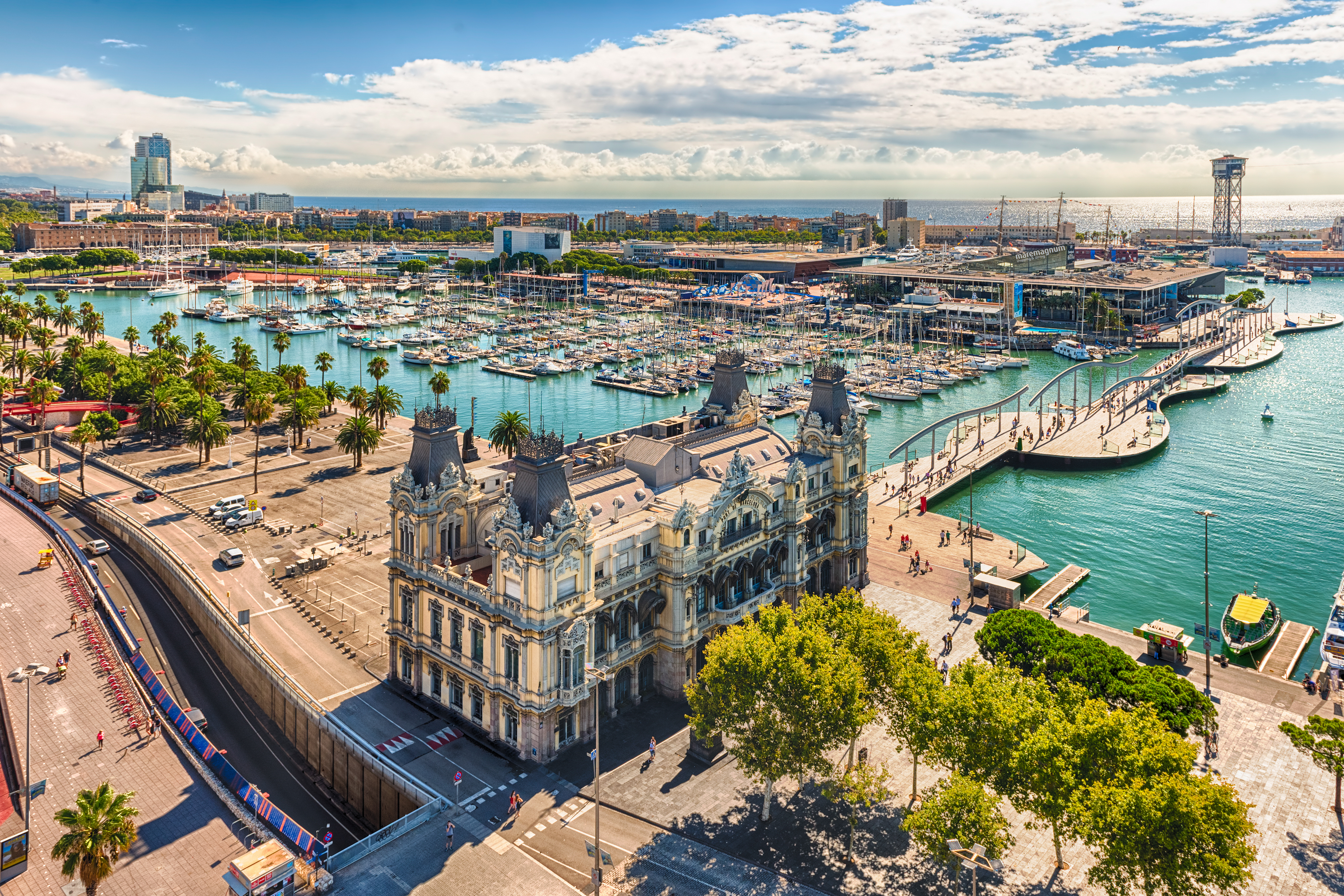 Barcelona Port Vell aerial: marina with yachts, historic building, Rambla de Mar.