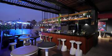 a bar with stools and tables