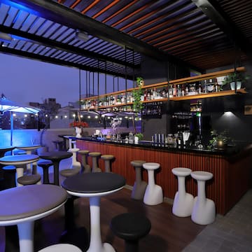 a bar with stools and tables