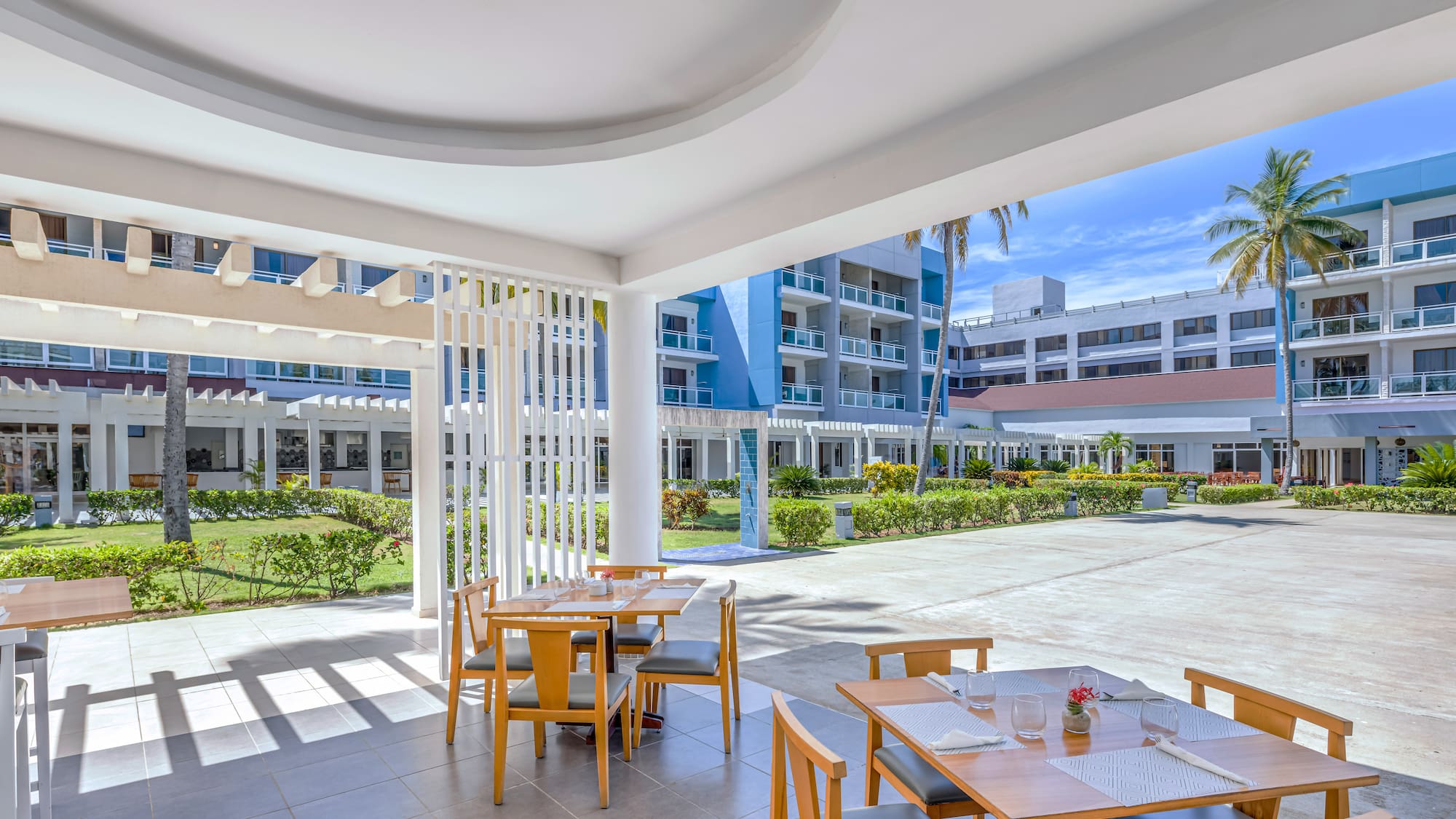 a patio with tables and chairs