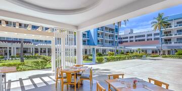 a patio with tables and chairs