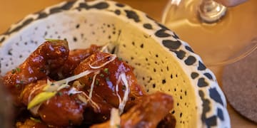 a hand holding a glass of wine