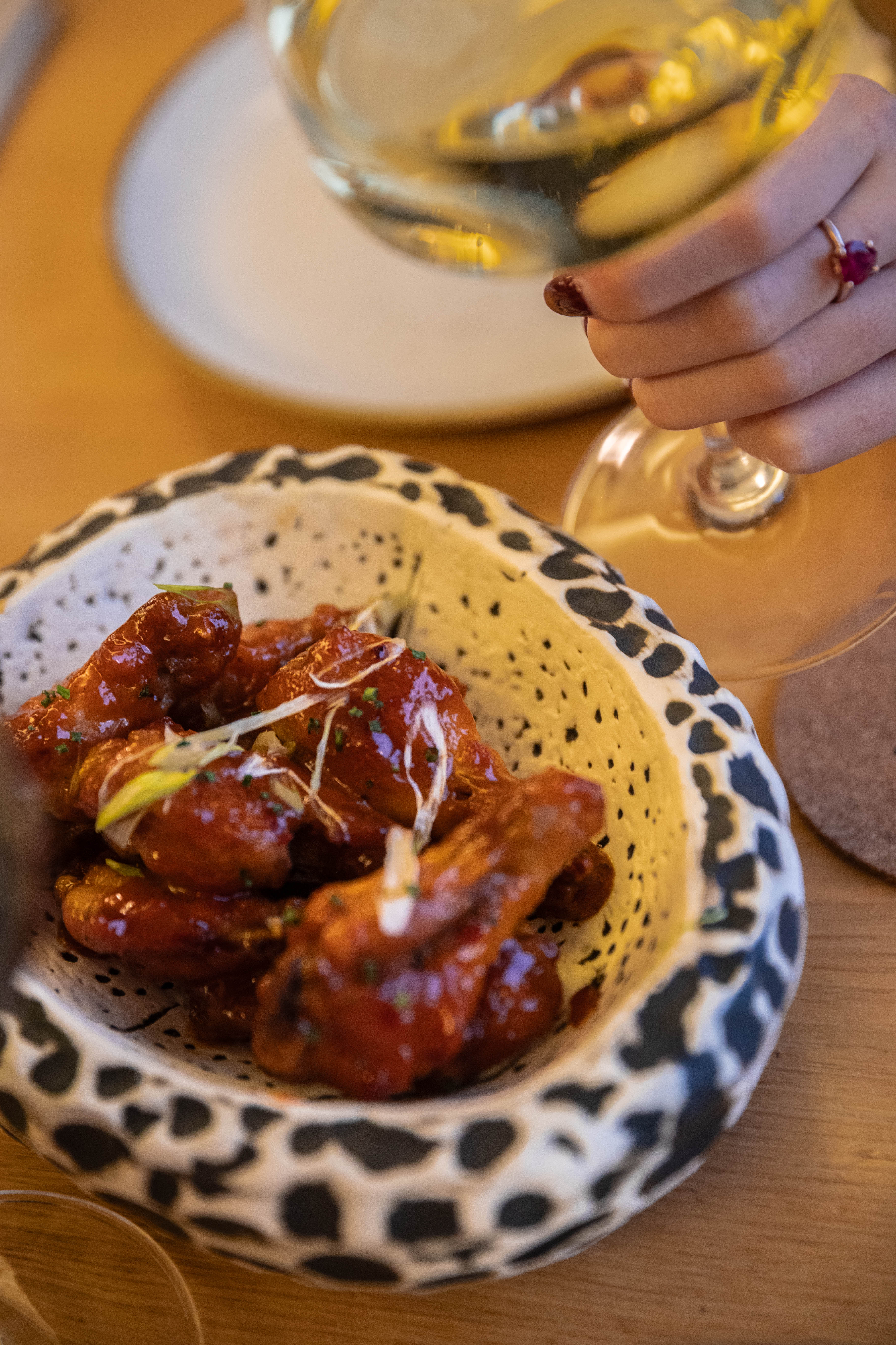 a hand holding a glass of wine