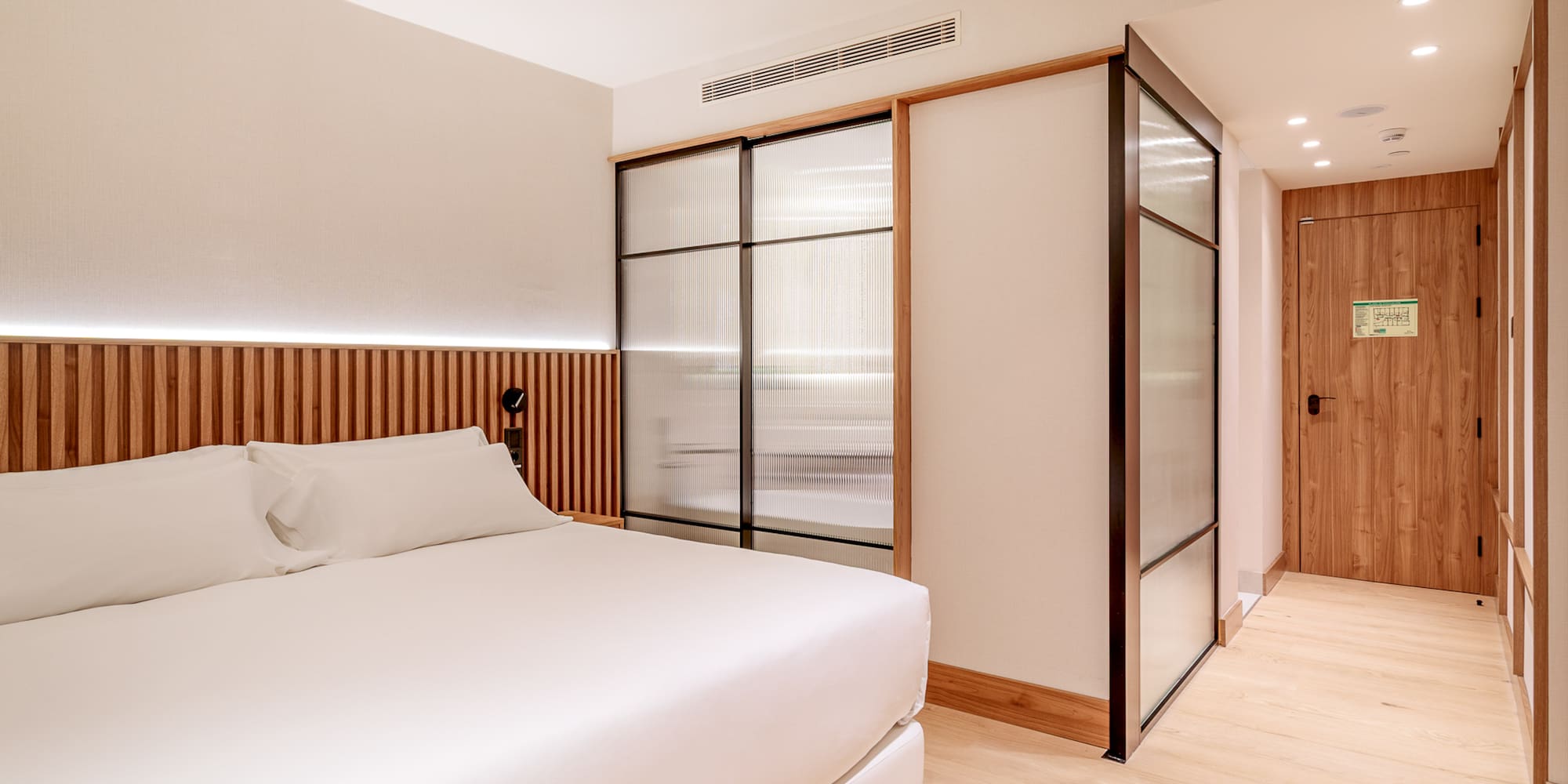 a room with a bed and sliding doors