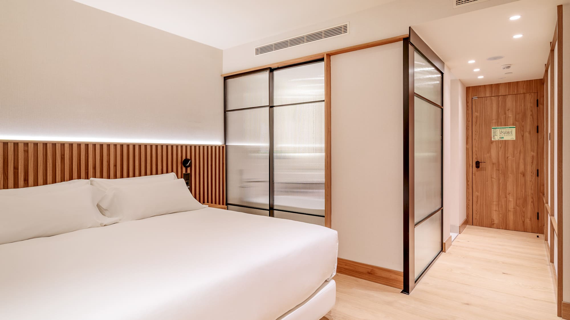 a room with a bed and sliding doors