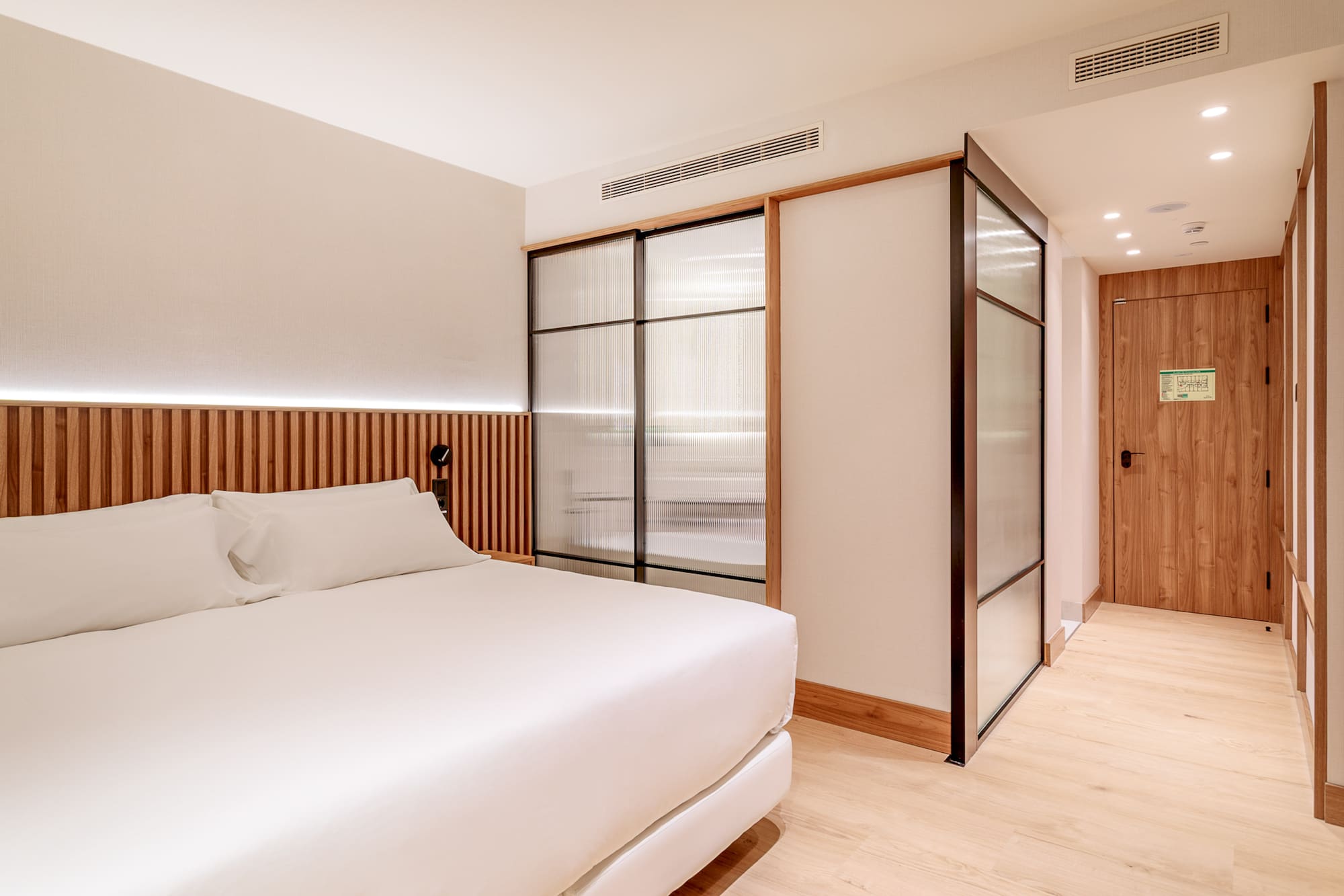 a room with a bed and sliding doors