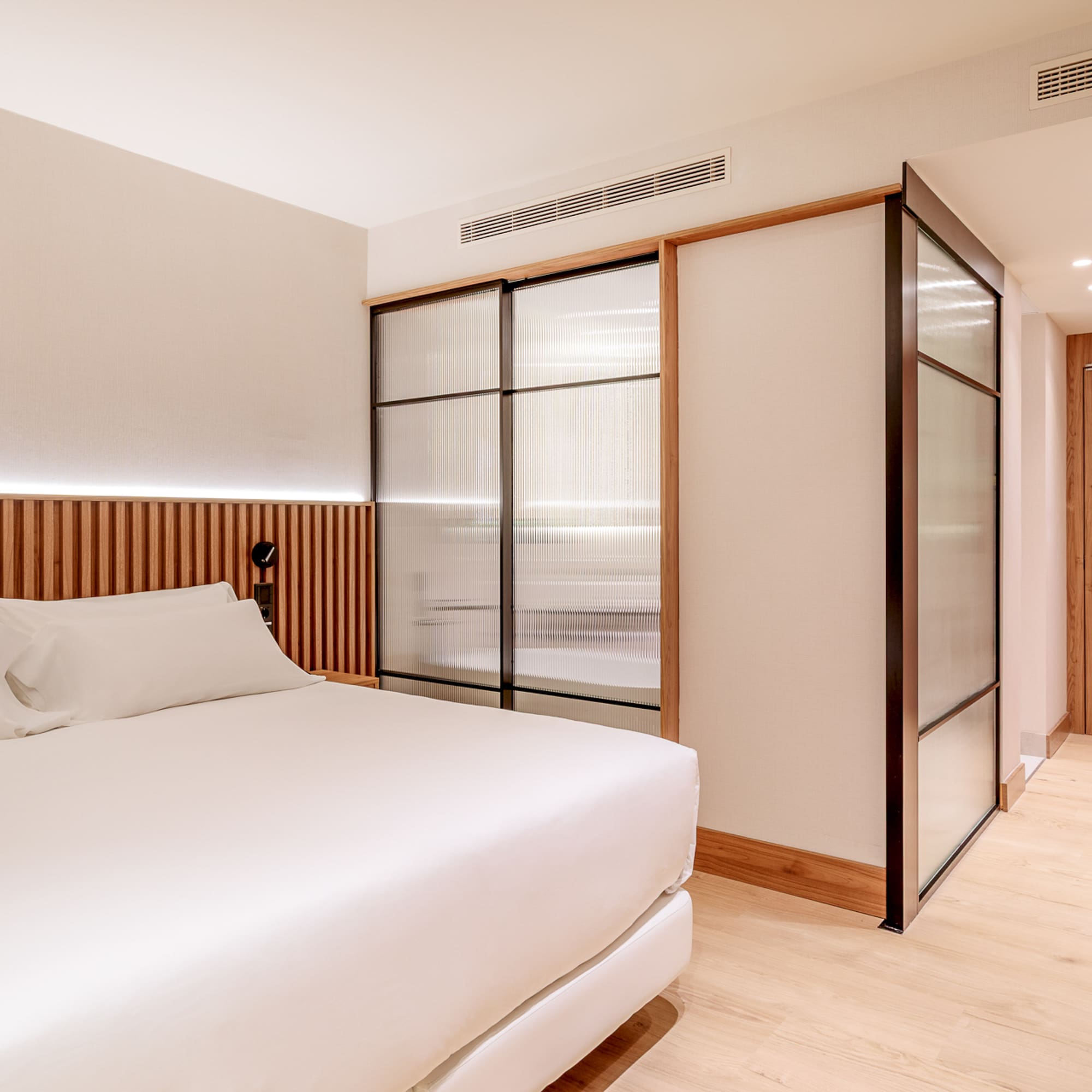 a room with a bed and sliding doors