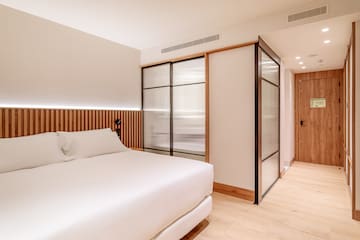 a room with a bed and sliding doors