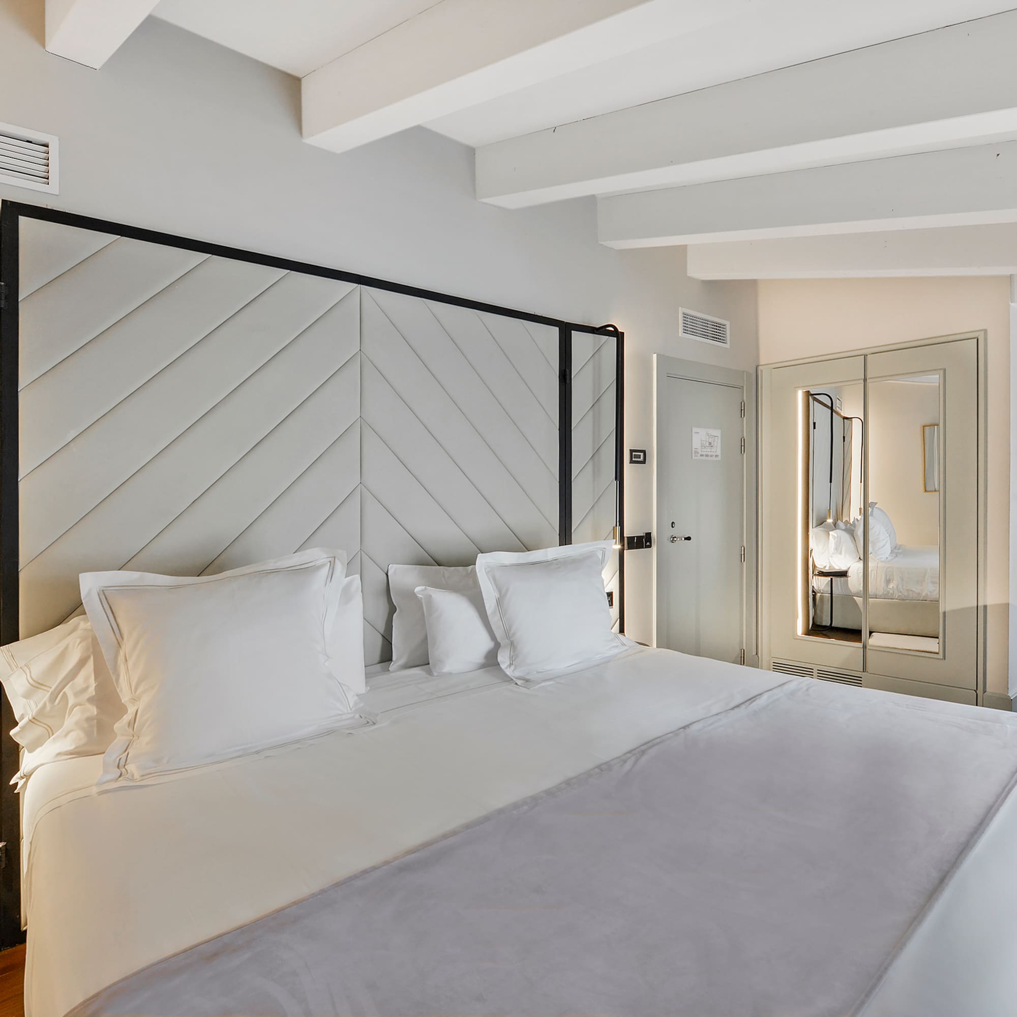 a bed with white pillows in a room