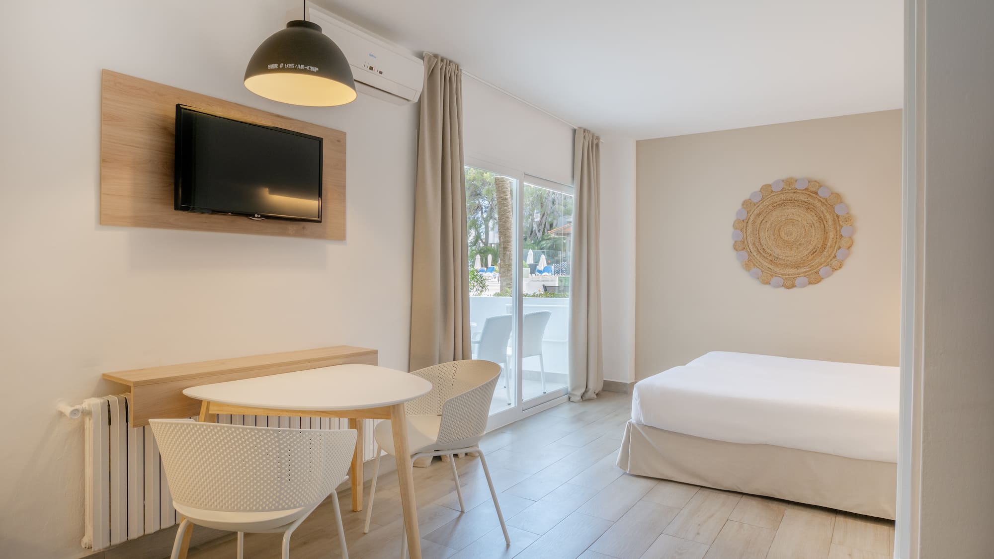 a room with a bed and a table and chairs