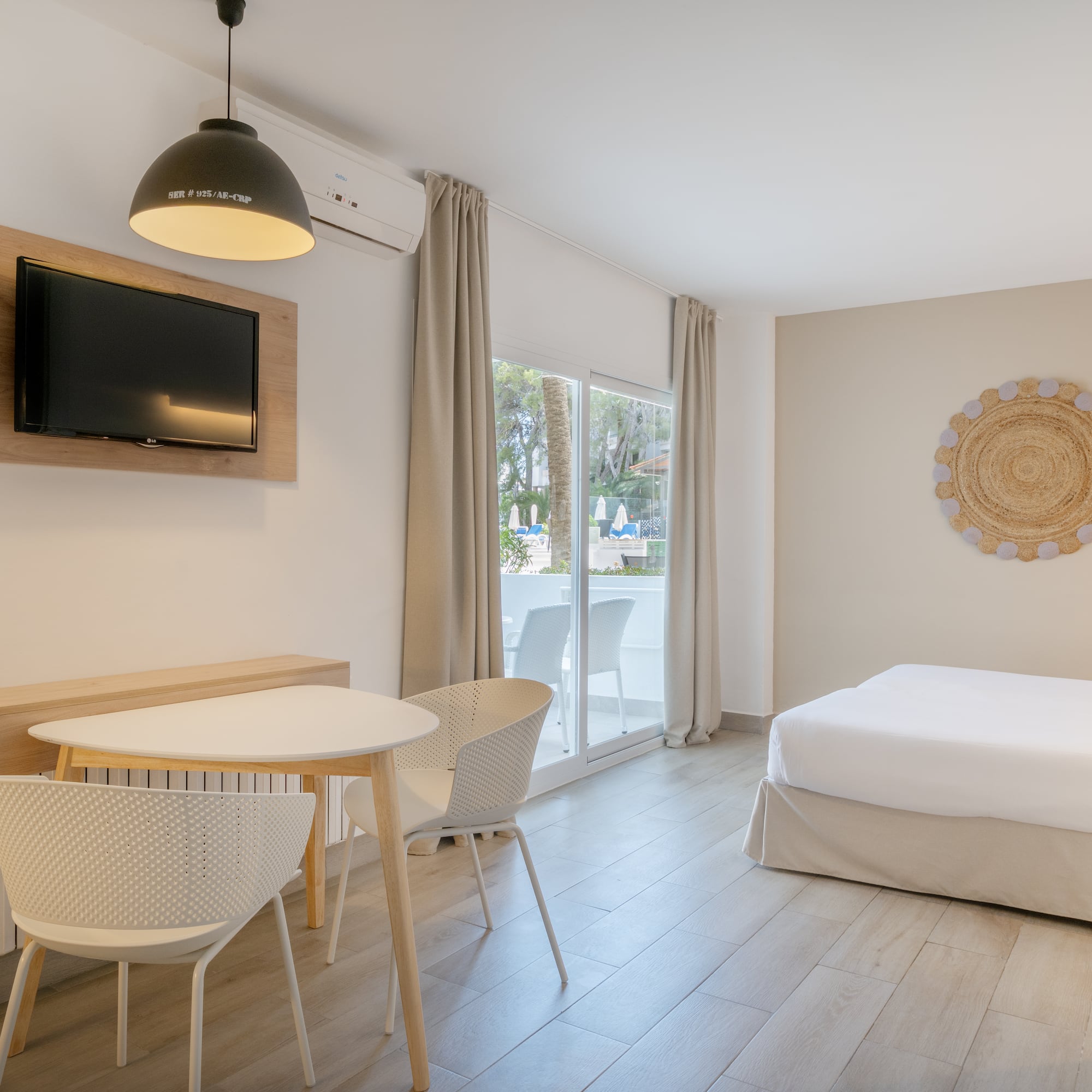 a room with a bed and a table and chairs