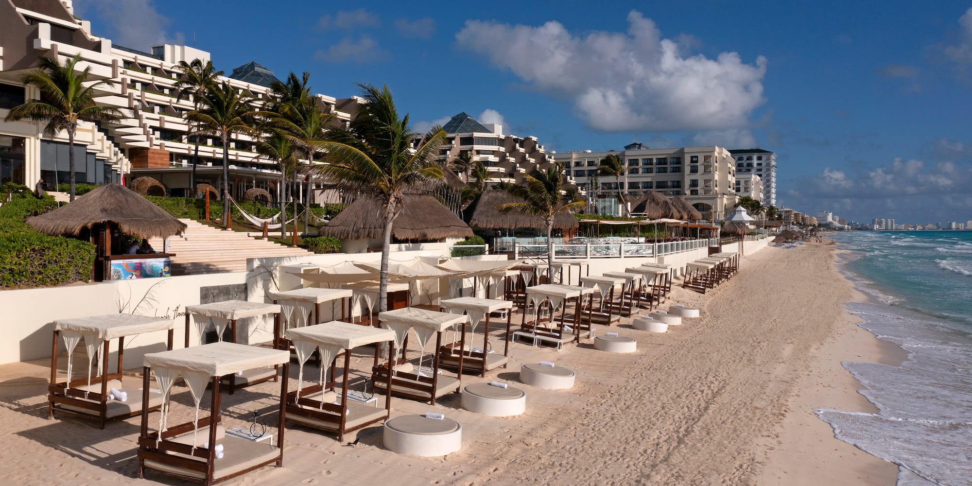 a beach with tables and chairs