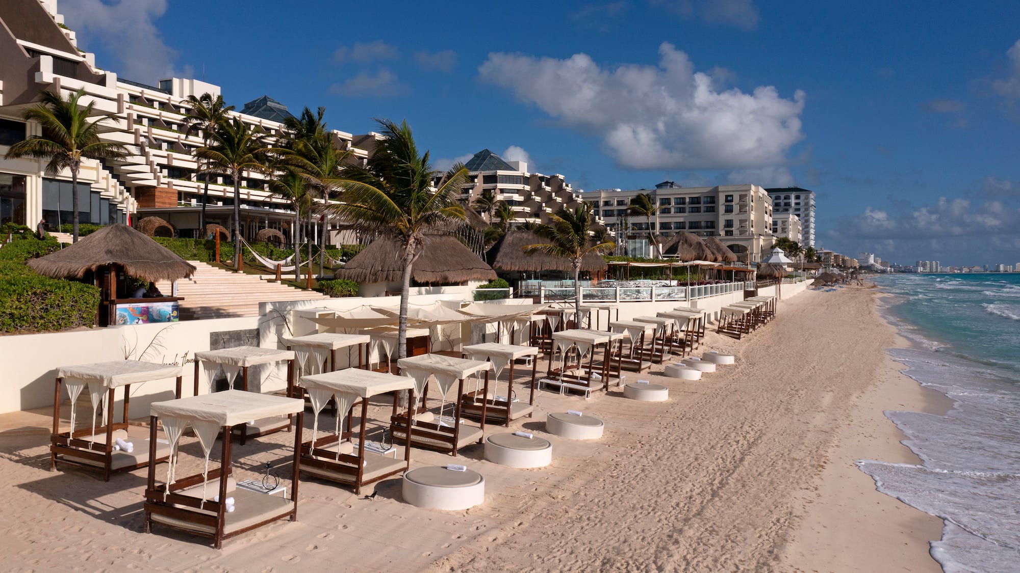 a beach with tables and chairs