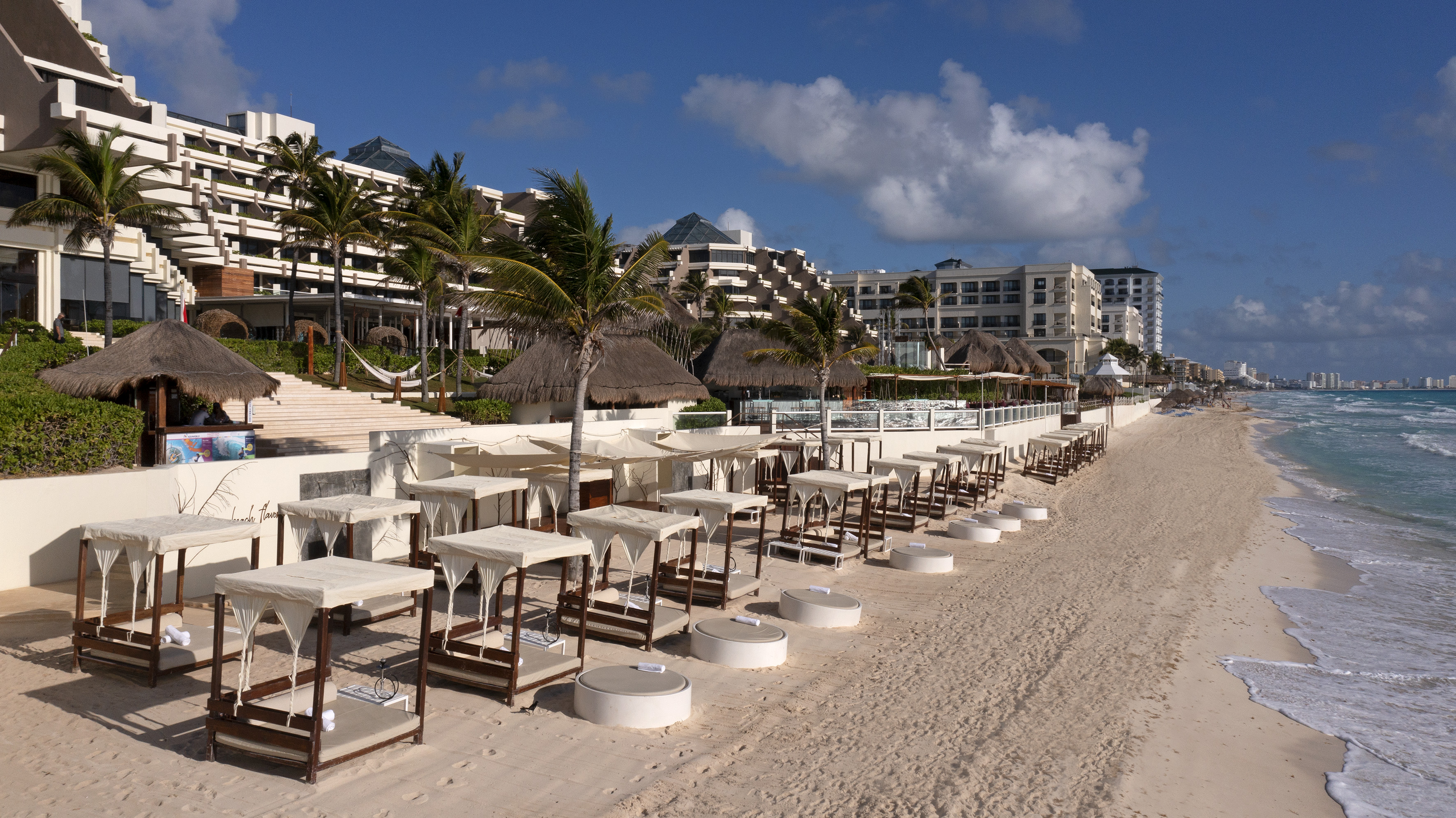 a beach with tables and chairs