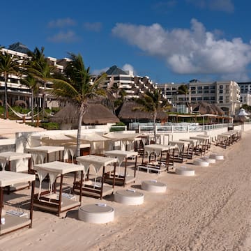 a beach with tables and chairs