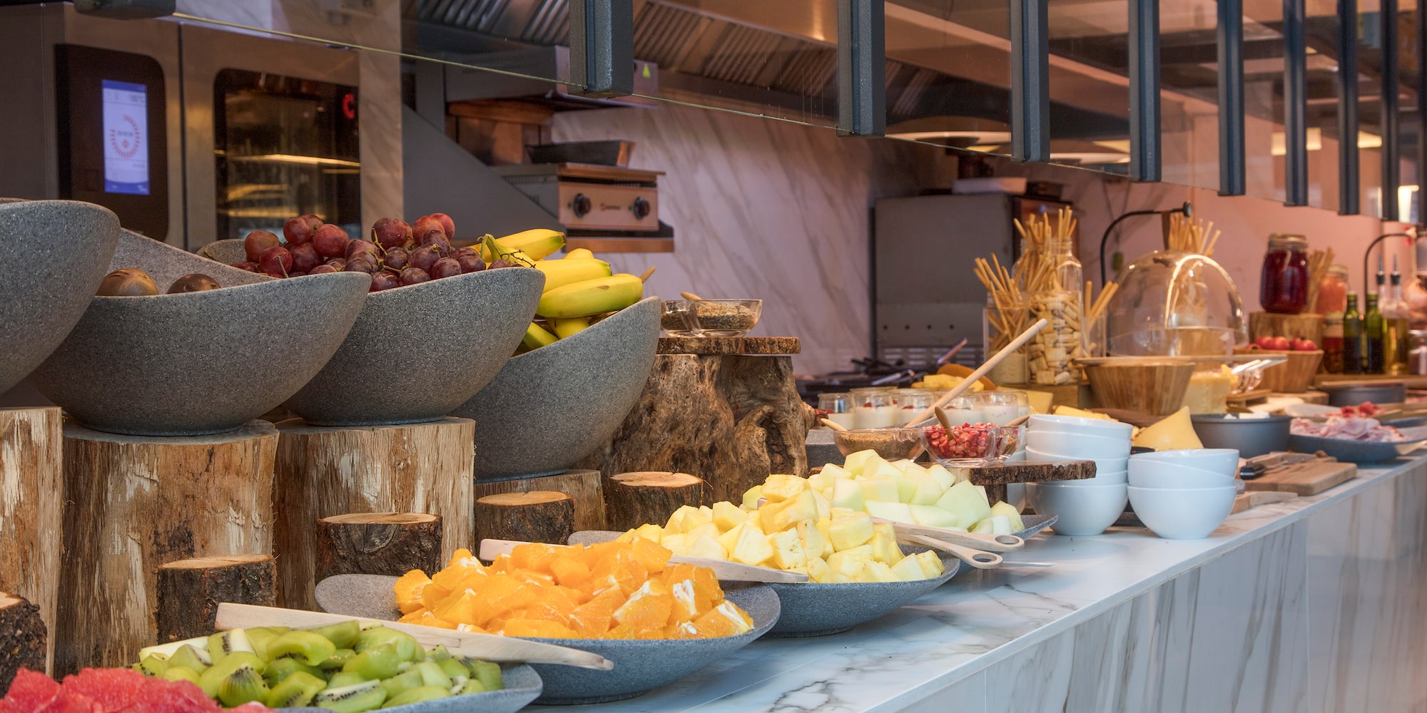 a counter with bowls of fruit
