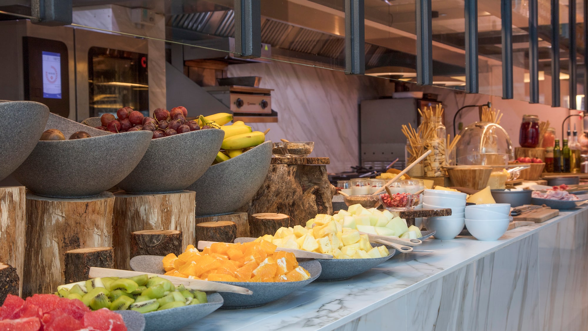 a counter with bowls of fruit