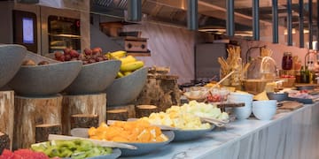 a counter with bowls of fruit