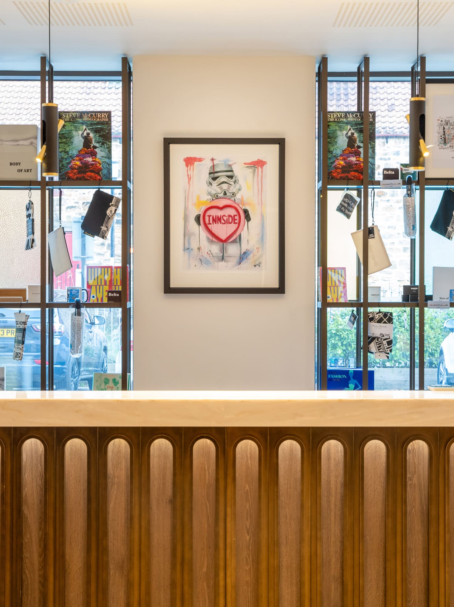 Modern hotel lobby counter with Stormtrooper art and retail display shelves.