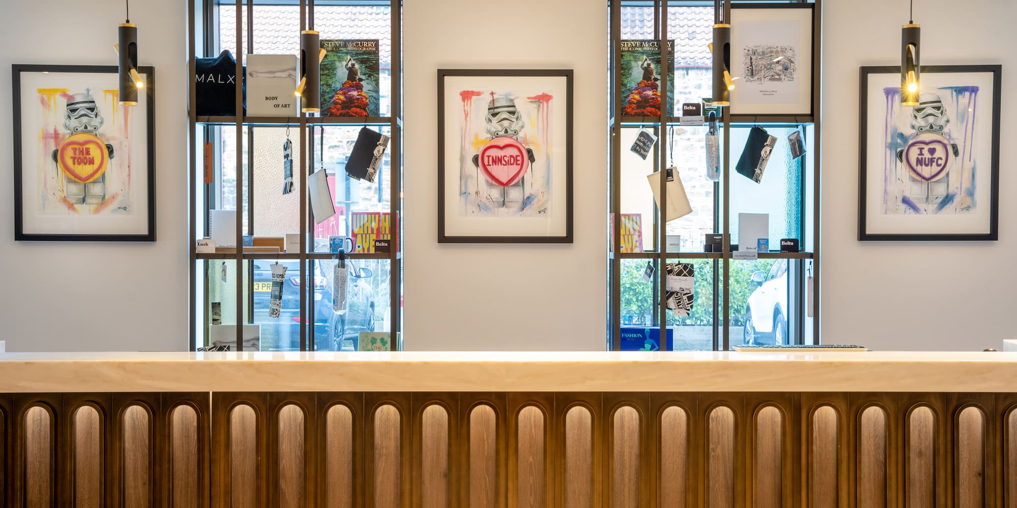 a reception desk in a room with art on the wall