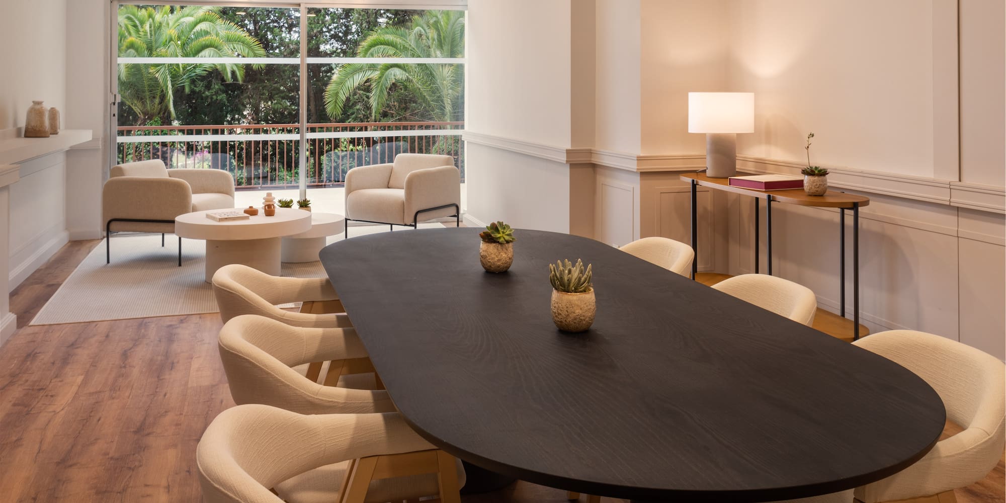 a room with a large window and a table with chairs and a table