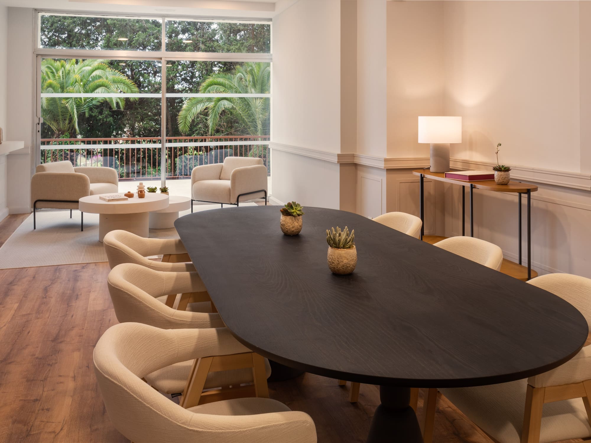 a room with a large window and a table with chairs and a table