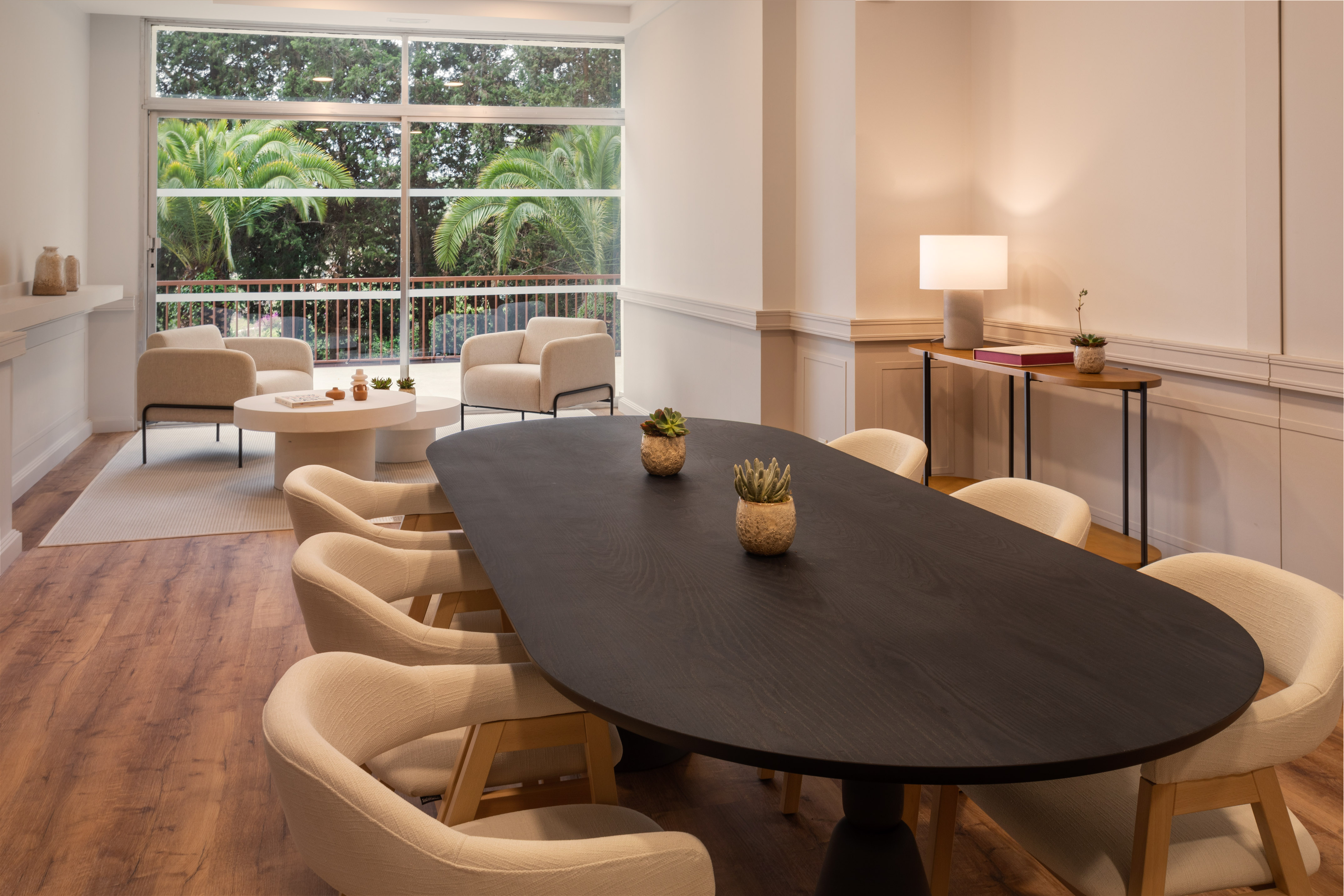 a room with a large window and a table with chairs and a table