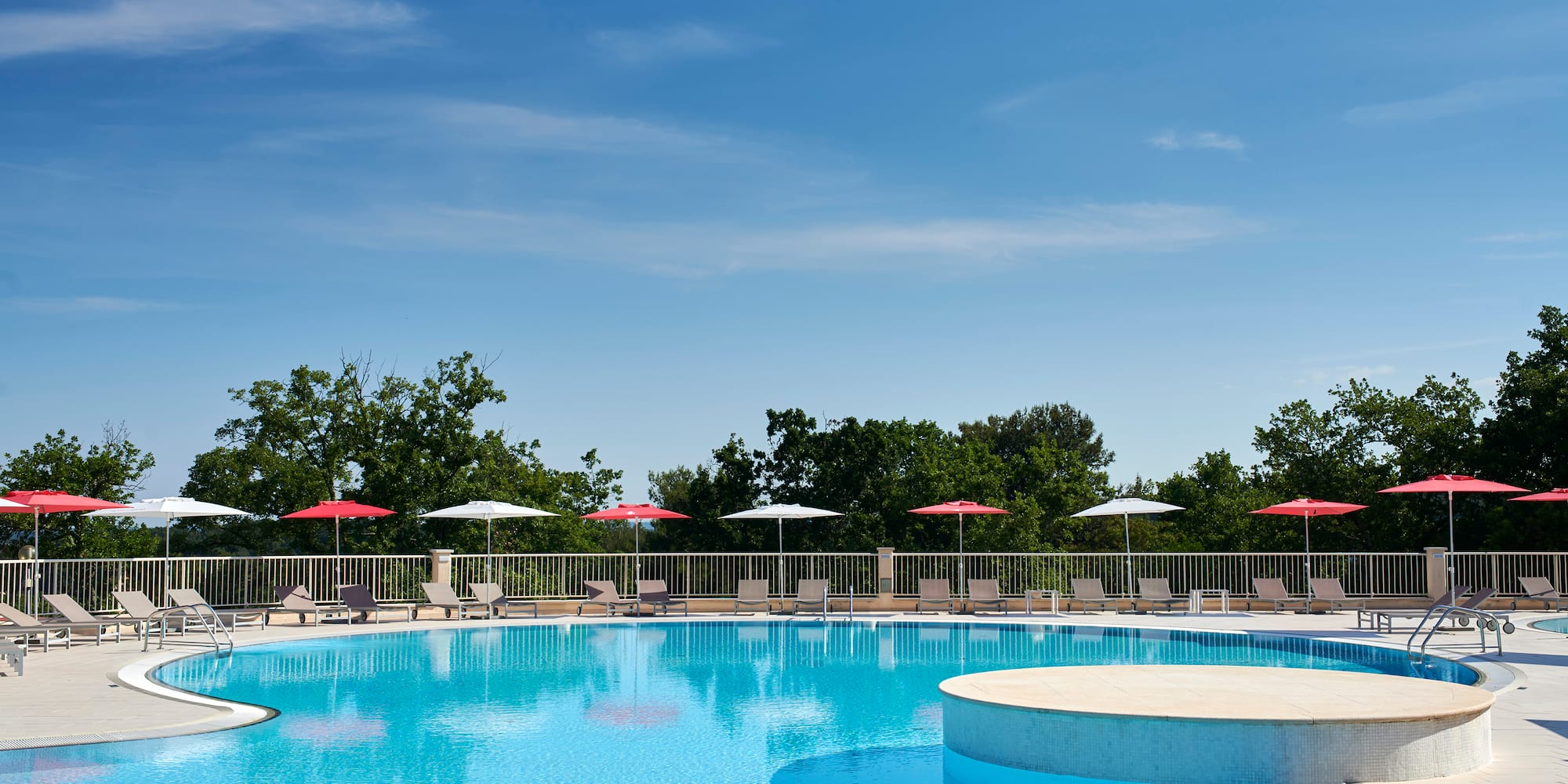 a pool with umbrellas and a deck