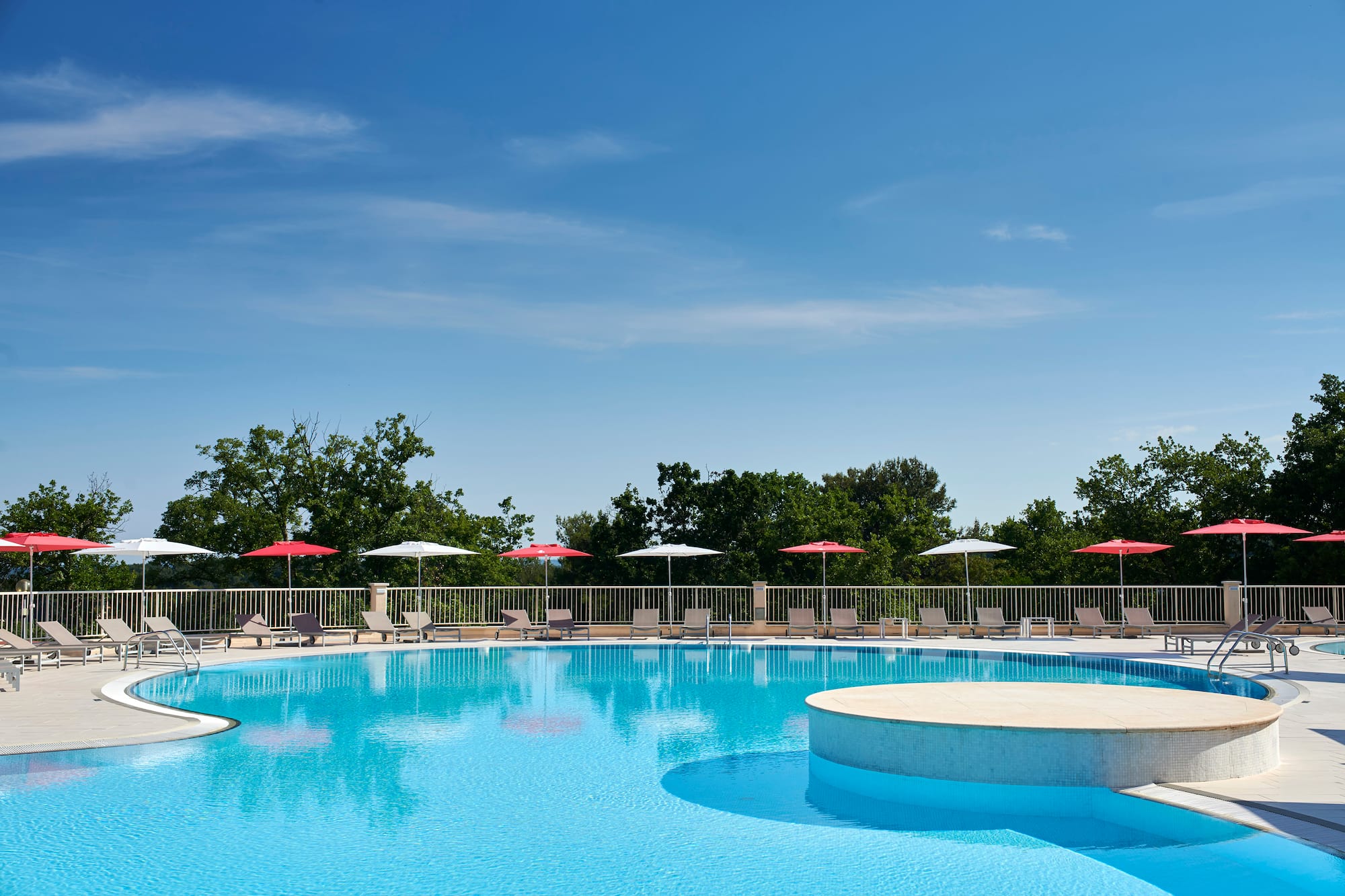 a pool with umbrellas and a deck