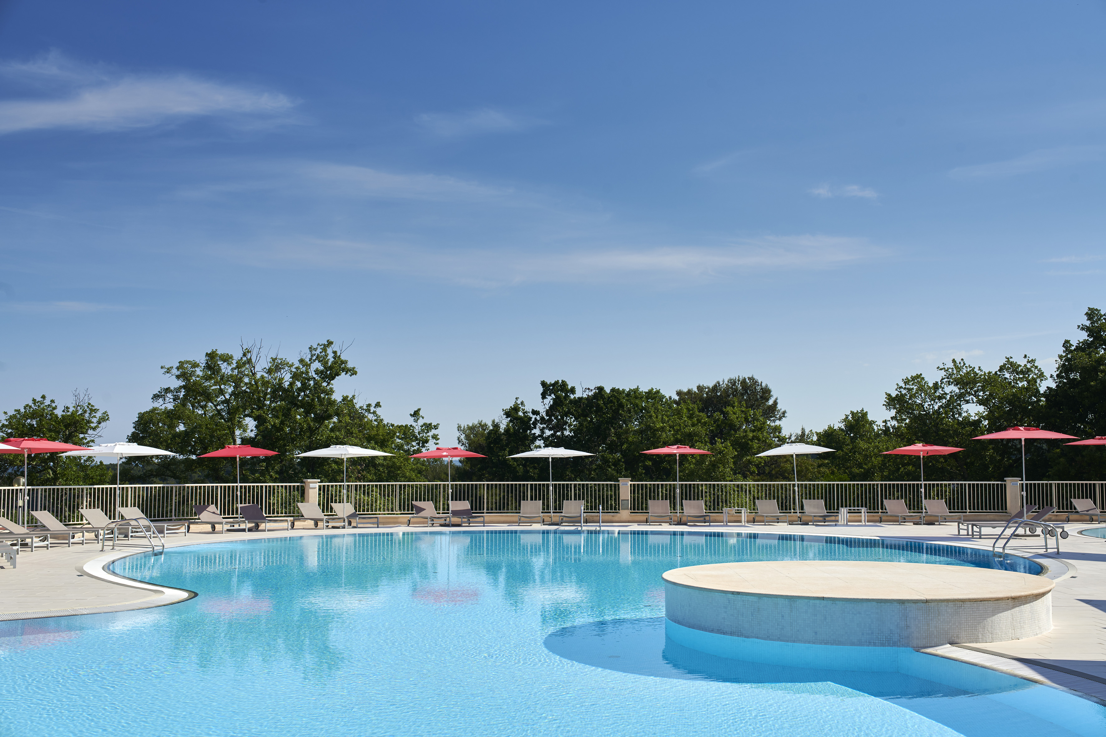 a pool with umbrellas and a deck