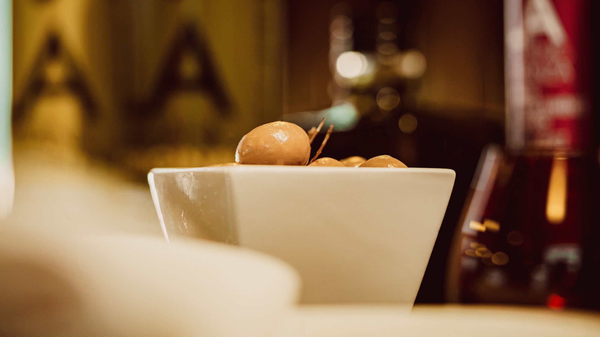 a bowl of olives on a counter