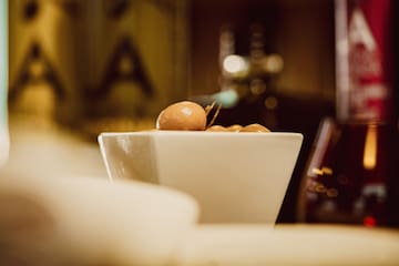 a bowl of olives on a counter