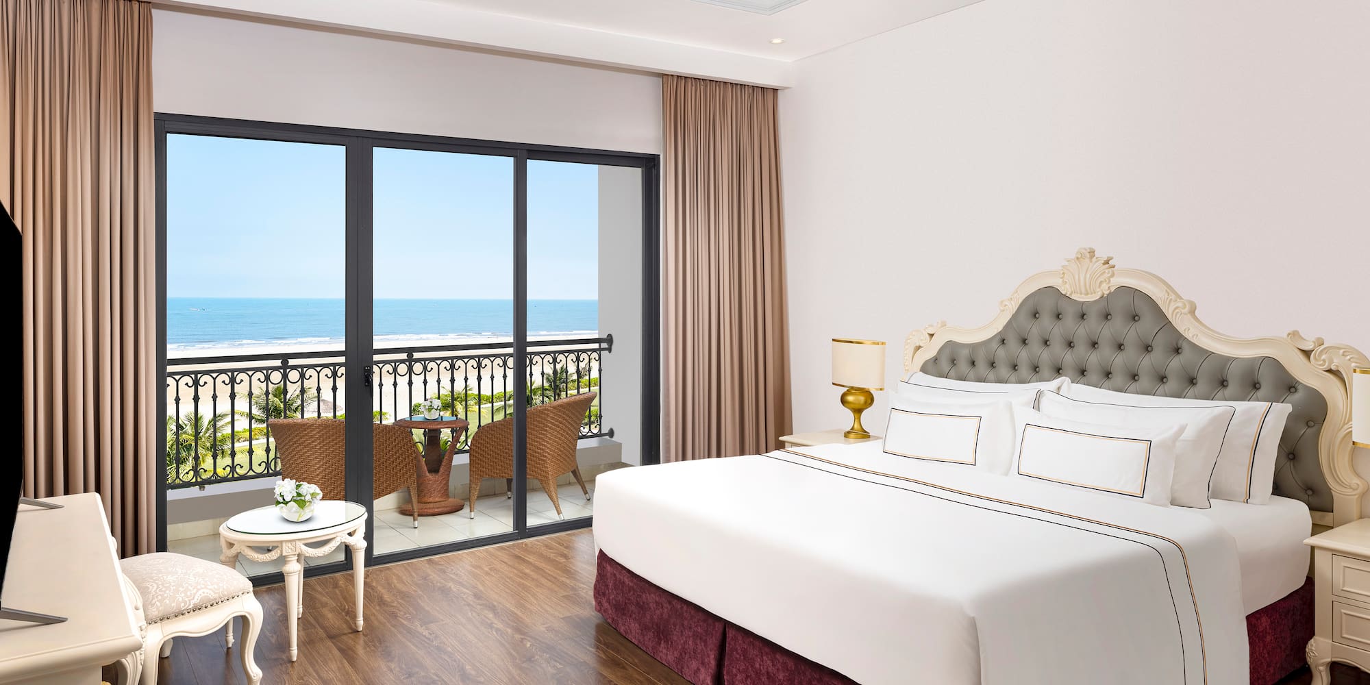 a bedroom with a balcony overlooking the ocean