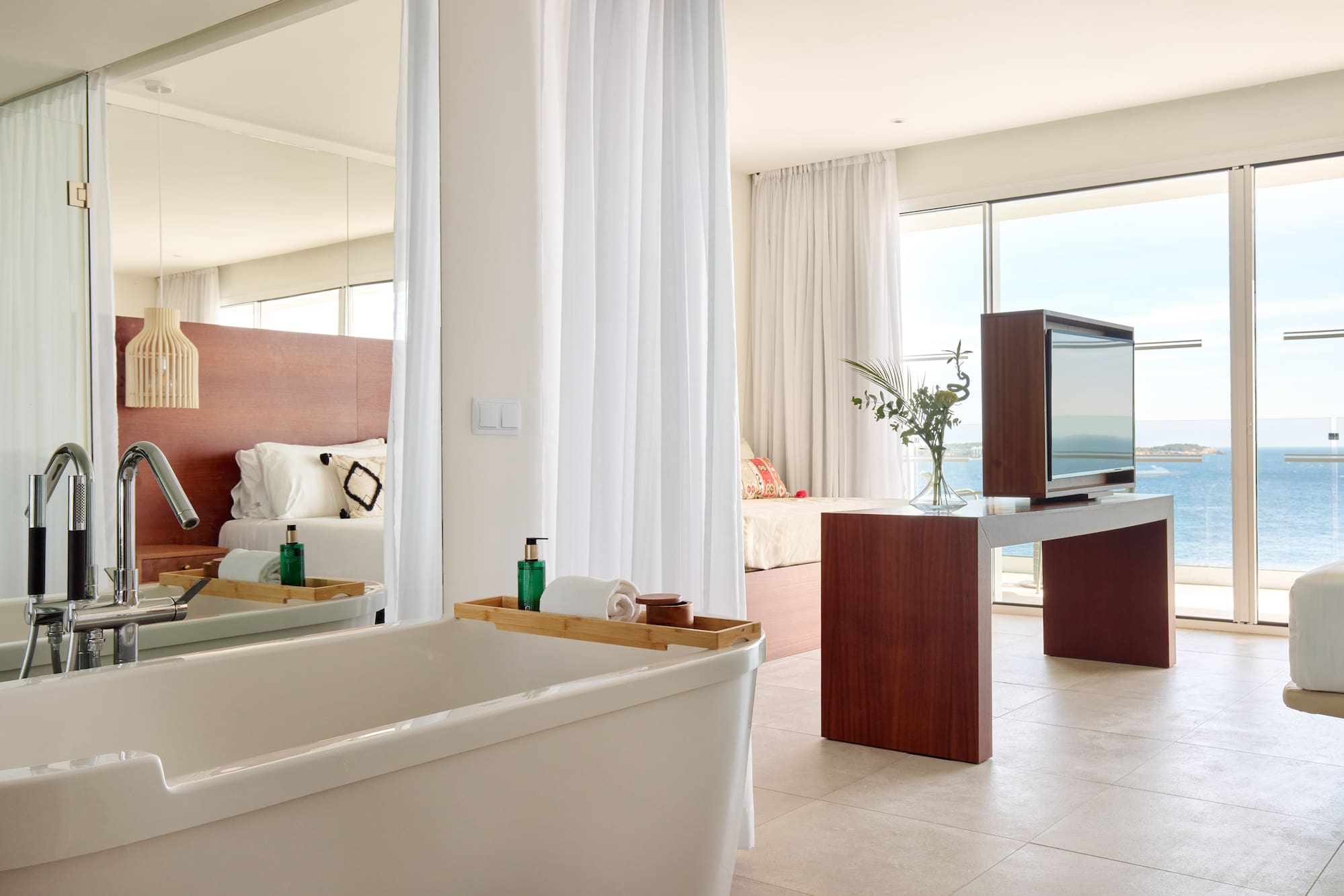 a bathroom with a large mirror and a tub
