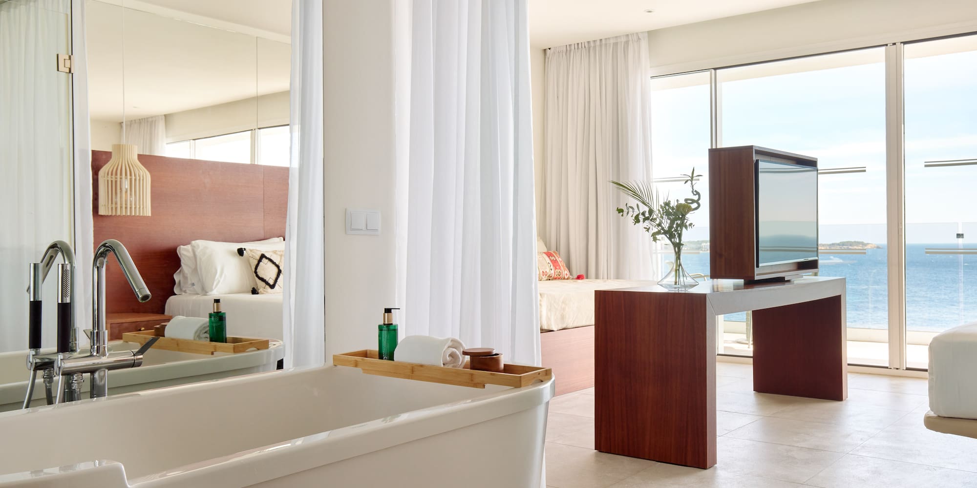 a bathroom with a large mirror and a tub