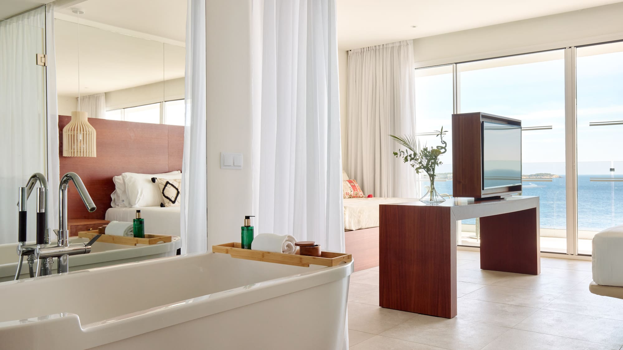 a bathroom with a large mirror and a tub